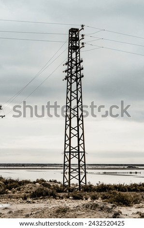 Industrial landscape (pylon) in the heart of the Camargue in a salt marsh exploitation