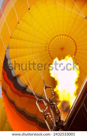 Glowing ascent: Interior view of a golden hot air balloon in Cappadocia, Turkey, capturing the mesmerizing moment of its fiery ascent Royalty-Free Stock Photo #2432533001