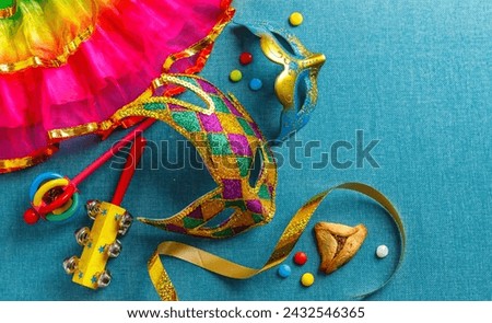 Beautiful white and multicolor carnival masks on a blue background. Purim, Mardi Gras holiday concept. View from above