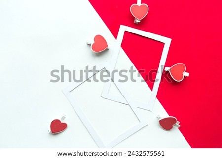 Two white mockup photo frames decorative with hearts on geometric white and red background. Minimal concept, copy space for the text. Valentine's Day greeting card