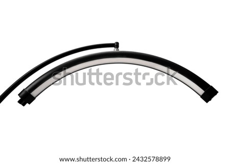 Modern LED floor lamp in the shape of a crescent. Lamp for minimalist interiors. Isolate on a white background. Royalty-Free Stock Photo #2432578899