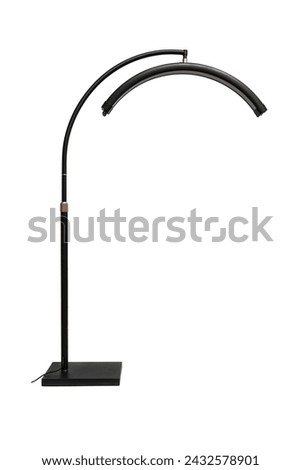Modern LED floor lamp in the shape of a crescent. Lamp for minimalist interiors. Isolate on a white background. Royalty-Free Stock Photo #2432578901