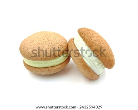 Close-up of two delectable macaron cookies isolated on a white background.