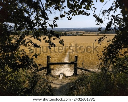 Stile to a footpath through a field in the Kent countryside. Location: near Snodland, Kent. Royalty-Free Stock Photo #2432601991