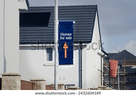 Home for sale sign at new housing development