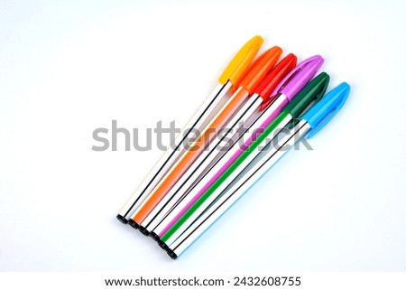 Close up view of multicolor ball point pen .Ballpoint pens. Choice of handles. Colored pens. Ink pens for writing. Pens lie on the notepad page. Office stationery concept. Royalty-Free Stock Photo #2432608755