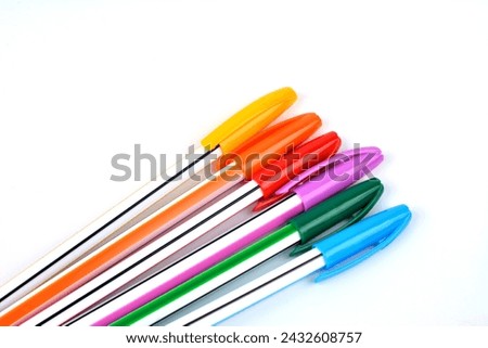 Close up view of multicolor ball point pen .Ballpoint pens. Choice of handles. Colored pens. Ink pens for writing. Pens lie on the notepad page. Office stationery concept. Royalty-Free Stock Photo #2432608757