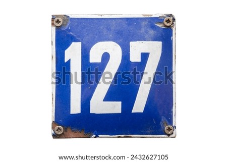 Weathered grunge square metal enameled plate of number of street address with number 127 isolated on white background