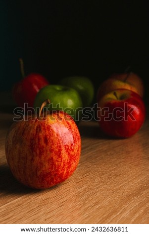delicious apples on a wooden table with light from a window,