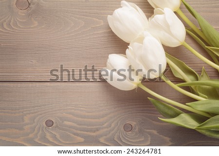 beautiful  white tulips on wooden background with copy space, springtime