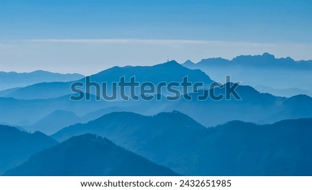 Panoramic view of magical mountain peaks of Karawanks and Julian Alps seen from Goldeck, Latschur group, Gailtal Alps, Carinthia, Austria, EU. Mystical atmosphere in Austrian Alps on sunny summer day. Royalty-Free Stock Photo #2432651985
