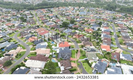 Drone aerial photograph of residential houses and surroundings in the greater Sydney suburb of Glenmore Park in New South Wales in Australia Royalty-Free Stock Photo #2432653381