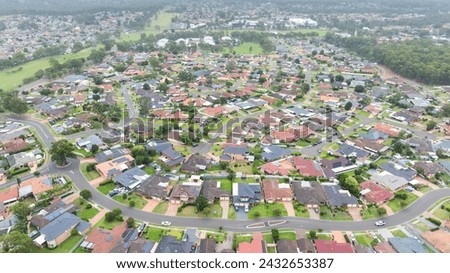 Drone aerial photograph of residential houses and surroundings in the greater Sydney suburb of Glenmore Park in New South Wales in Australia Royalty-Free Stock Photo #2432653387