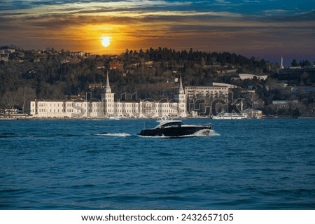 Power boat taxi in Bosphorus Strait moving fast and splashing water. Anatolian Site of Istanbul and Bosphorus Bridge in the background.