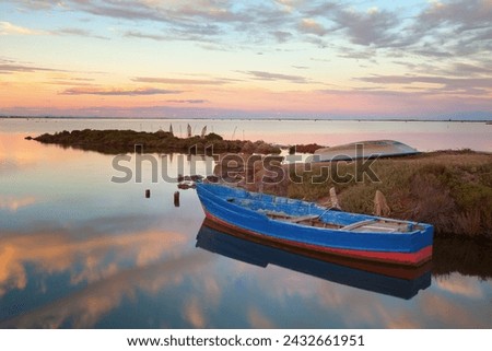 Fishing boats in a natural harbor in Fangar bay, Ebro Delta, Tarragona, Spain