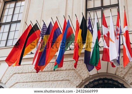 National flags of various countries flying in the wind. Colorful flags from different countries. Flags Organization for Security and Co-operation in Europe Royalty-Free Stock Photo #2432666999
