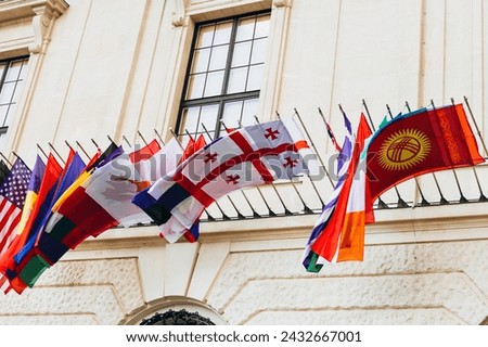 National flags of various countries flying in the wind. Colorful flags from different countries. Flags Organization for Security and Co-operation in Europe Royalty-Free Stock Photo #2432667001
