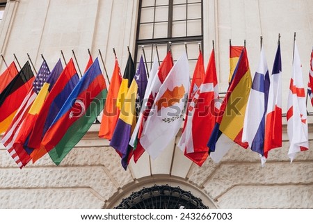 National flags of various countries flying in the wind. Colorful flags from different countries. Flags Organization for Security and Co-operation in Europe Royalty-Free Stock Photo #2432667003