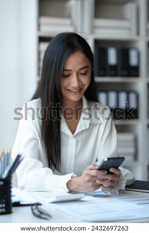 Accountant, Asian independent business woman Positive concept using smartphone to relax with mobile app and use chat business communication Contact online marketing that is extremely profitable.
