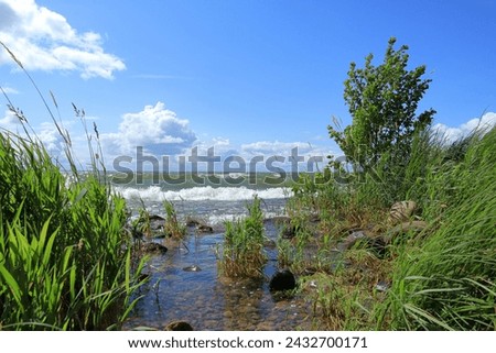 Hindens rev at Vänern. The biggest lake in Sweden. Large wet rocks. Windy outside this summer day. Near Lidköping. Royalty-Free Stock Photo #2432700171