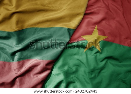 big waving national colorful flag of burkina faso and national flag of lithuania . macro