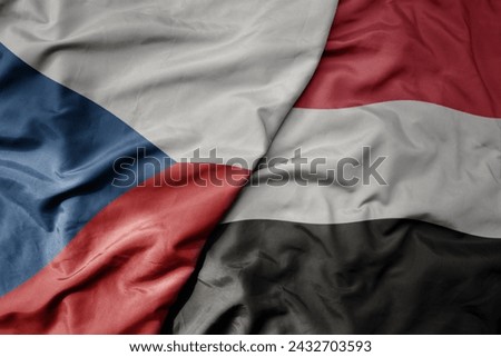 big waving national colorful flag of yemen and national flag of czech republic. macro
