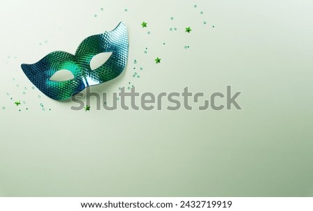 Happy Purim carnival decoration concept made from green mask star and glitter on pastel background. (Happy Purim in Hebrew, jewish holiday celebrate)