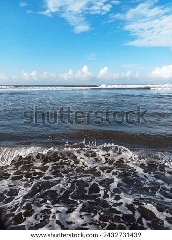 vertical photo of beautiful waves on the beach in the morning