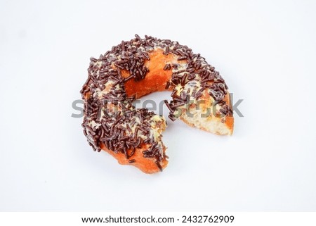 Half eaten chocolate sprinkle donut isolated on white background.