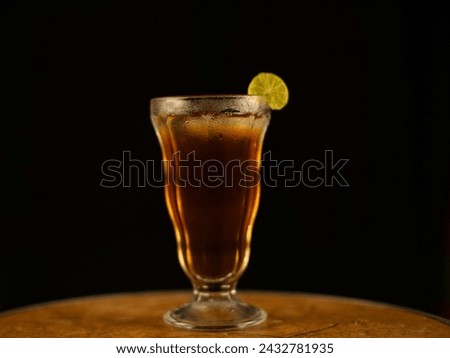 Iced lime tea isolated on black background