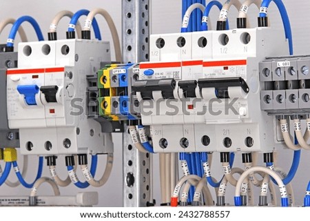 Electric circuit breakers for the protection of electrical loads.  Royalty-Free Stock Photo #2432788557