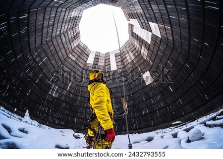 Rope access specialist in a cooling tower. A worker inspects the building