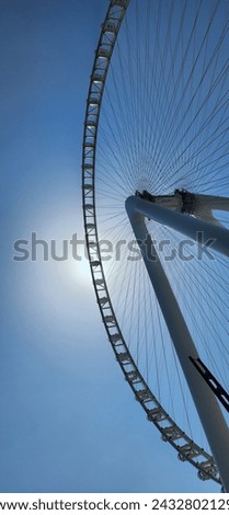 Summertime Wide Angle Details on the Ferris Wheel metal Beams and Passenger Capsule Booths. Dubai Eye on Bluewater Island Royalty-Free Stock Photo #2432802129