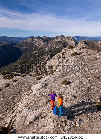 Two women hikers enjoying the beautiful nature from high above, Famorca, Alicante, Costa Blanca, Spain - stock photo