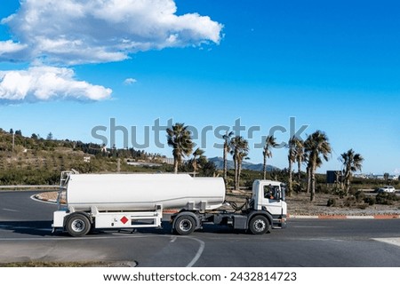 Single-axle fuel tanker truck, truck with short semi-trailer to access difficult and complicated sites. Royalty-Free Stock Photo #2432814723