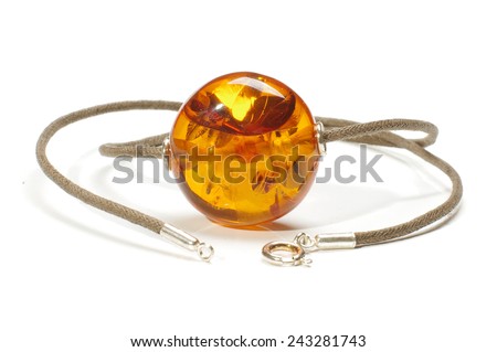 Big amber charm isolated on the white background Royalty-Free Stock Photo #243281743