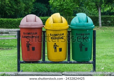 Trash bin with text " sampah limbah B3 it means B3 waste, sampah kering it means dry, sampah basah it means wet"  Royalty-Free Stock Photo #2432824425
