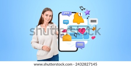 Smiling woman showing mock up empty phone display, colorful social network icons with web search, notification and hearts. Concept of mobile app and communication