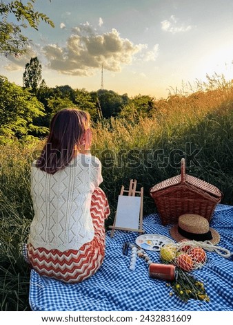 Painter's paradise: woman creates art during a picnic.