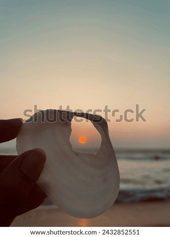 Looking through a seashell. Chillaw beach view. It shows the beauty of the sunset and the ocean view. This picture Captured by an iPhone