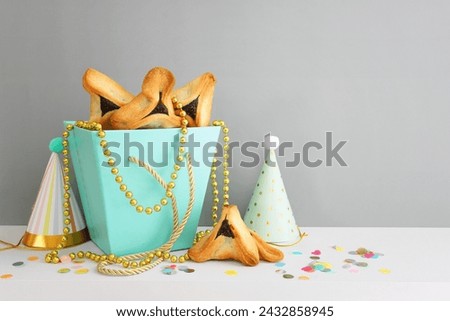 Purim celebration concept (jewish carnival holiday). Hamantaschen cookies over white table