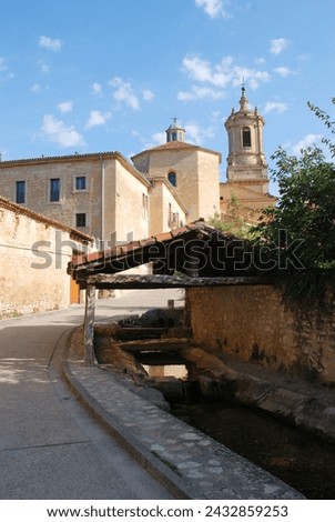 Street and monastery. Santo Domingo de Silos, Burgos province, Castilla Leon, Spain. Royalty-Free Stock Photo #2432859253
