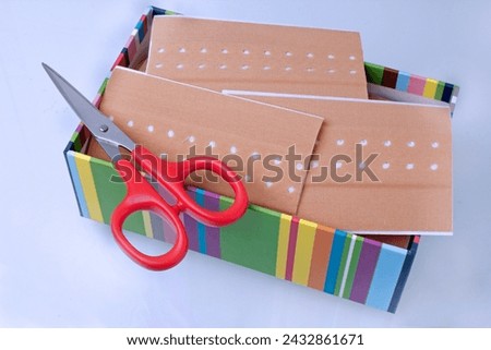 Plaster with scissors in box