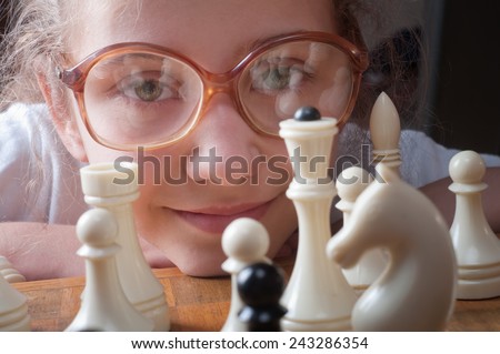 little girl plays chess