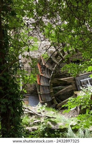 Paddlewheel on the banks of the Veules, France's smallest river, approx. 1km long Royalty-Free Stock Photo #2432897325