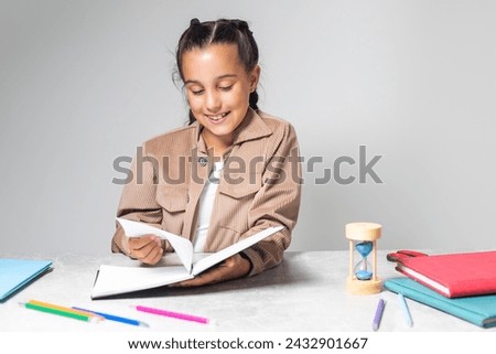 Beautiful dark-eyed dark-haired girl smiling and studying