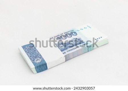 Pakistan one thousand rupees denomination note bundle on white isolated background Royalty-Free Stock Photo #2432903057