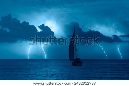Sailing yacht in a stormy weather with thunder and lightning