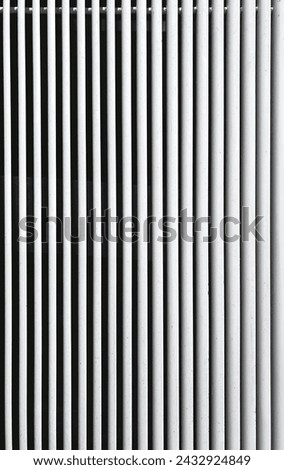 Minimalist Monochrome: Parallel White Pipes on a Wall. The Simplicity and Symmetry of Modern Industrial Design