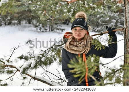 Winter photo shoot of a beautiful woman in a winter snowy forest.
